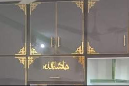 Large dark-colored wardrobe decorate with corner triangle shape acrylic designs in a room setting