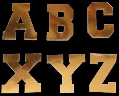 Golden acrylic letters A, B, C, X, Y, Z in a gothic font, displayed against a white background.