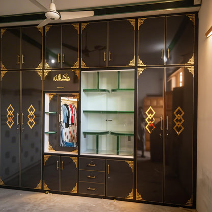 Black wardrobe with gold accents in a room setting