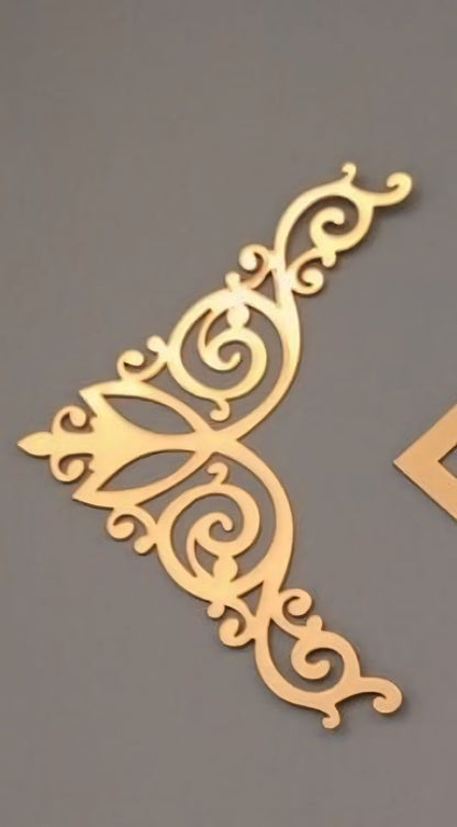 A gold-colored, triangle-shaped acrylic craft base T-2 design with intricate detailing, intended for use in arts and crafts.