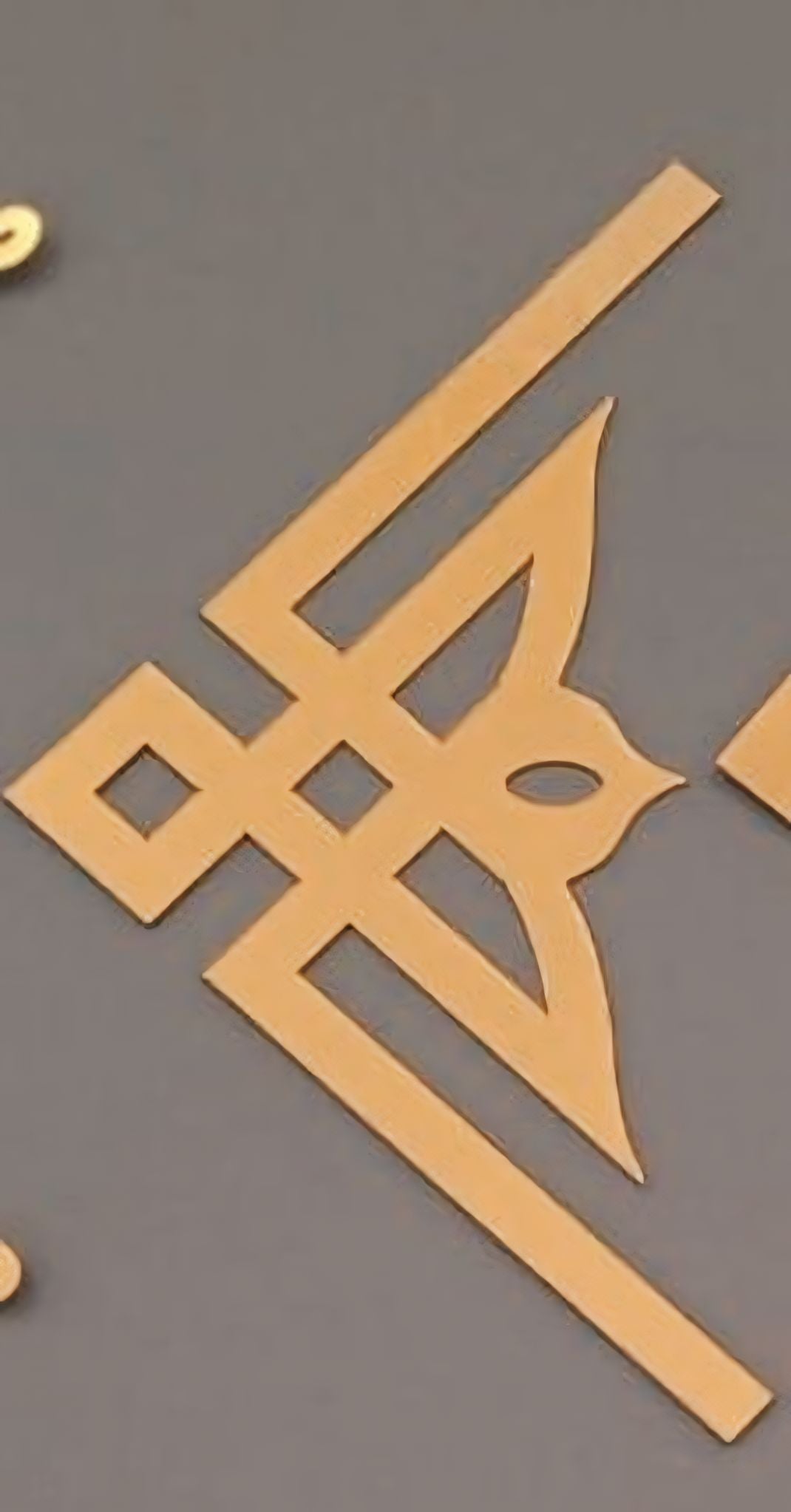 A triangle-shaped acrylic craft base T-3 design displayed on a flat surface.